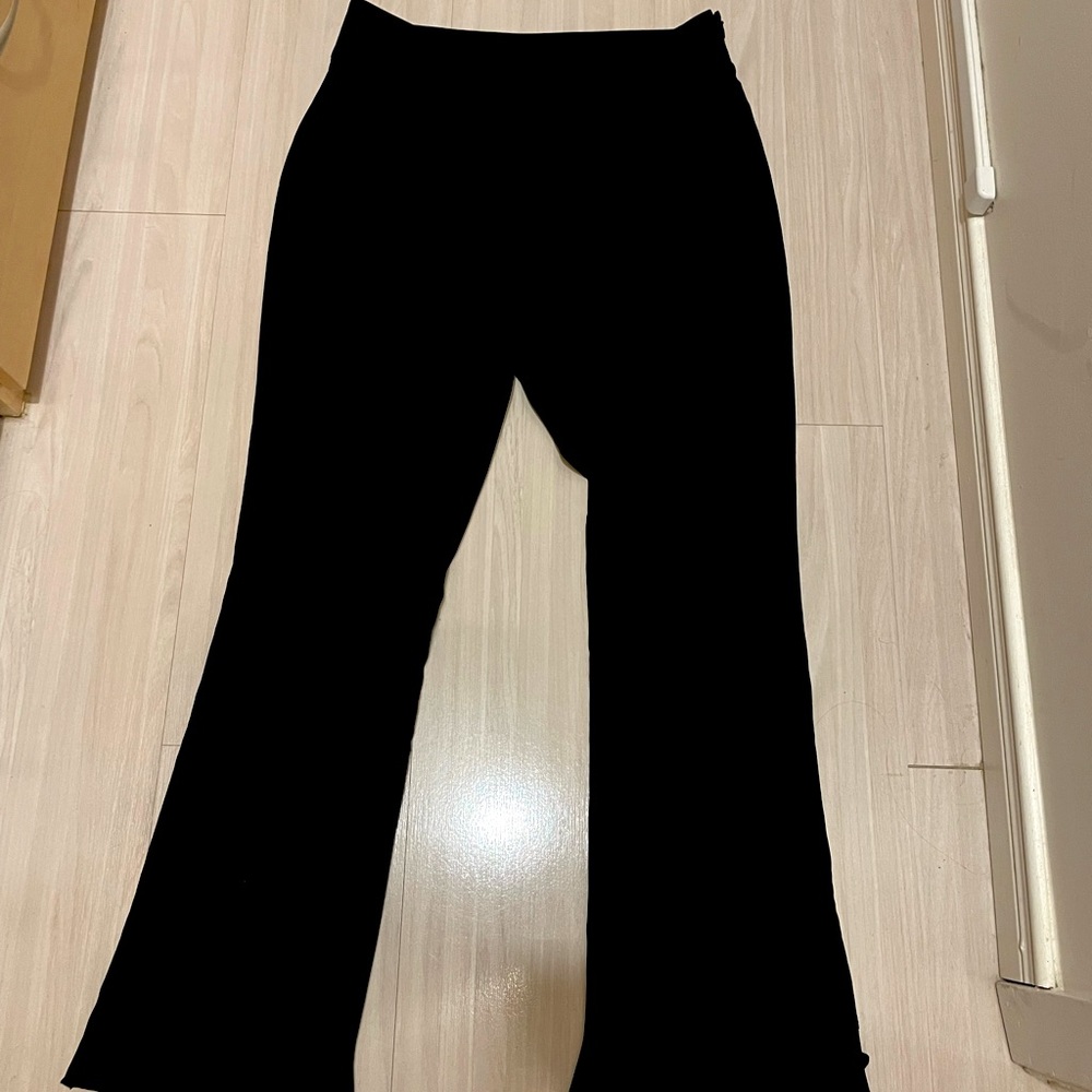 Black dress pants with scallop hem.